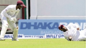 THAT’S NOT THE WAY: West Indies fielder Darren Bravo fails to take a catch in the first Test against Bangladesh at Arnos Vale Sports Complex, Kingstown, St Vincent on Tuesday. At left, captain Denesh Ramdin is far from amused. Despite sloppy fielding, West Indies won the match by 10 wickets.