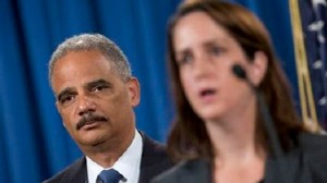 Attorney General Eric Holder listens at left during a news conference at the Justice Department in Washington, Thursday, September 4, to announce the Justice Department's civil rights division will launch a broad civil rights investigation in the Ferguson, Police Department. At right is Acting Assistant Attorney General for Civil Rights Division Molly Moran. (Photo:AP)