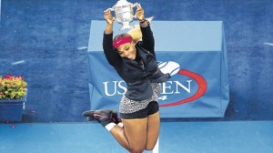 Serena Williams of the United States jumps into the air with trophy in hand after defeating Caroline Wozniacki of Denmark to win the women's singles final of the US Open at the USTA Billie Jean King National Tennis Center in Queens, New York, yesterday. (PHOTO: AFP)