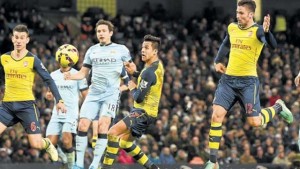 Arsenal’s French striker Olivier Giroud (second right) scores their second goal during the English Premier League football match against Manchester City at the Etihad Stadium in Manchester, north-west England, yesterday. (PHOTO: AFP)