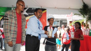 Chairman of the PEP Steering Committee, Mr Elvis Newton (2nd left) presenting a token of appreciation to one the women PEP workers, Ms Sharmen Jeffers. Looking on are Mr Geoffrey Hanley (left) and Ms Shelley Nisbett (right), both of PEP.