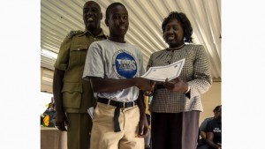 T'Shawn Grant receives TAPS certificate from Permanent Secretary Her Excellency Astona Browne, Anti Crime Unit. Police Commissioner Celvin G. Walwyn looks on