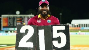 Chris Gayle poses with the score board figures following his record-breaking feat against Zimbabwe. (WICB Media) 