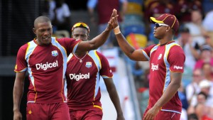 Sheldon Cottrel high fives Marlon Samuels