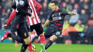 Liverpool's Brazilian midfielder Philippe Coutinho (right) shoots to score the opening goal during the English Premier League match against Southampton at St Mary's in Southampton, yesterday.
