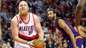 Trail Blazers center Chris Kaman goes to the basket against Suns forward Brandan Wright.