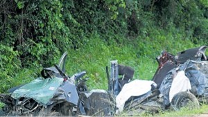 The crumpled remains of the blue Toyota Yaris motor car which crashed into a truck laden with sand along the Braco section of the North Coast Highway, yesterday, killing four foreign nationals. (PHOTO: HORACE HINES)