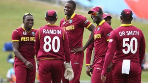 Windies skipper Jason Holder (centre) celebrate one of his four wickets with team-mates