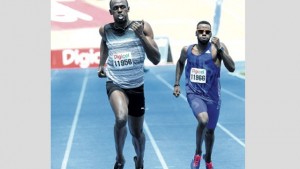 World superstar Usain Bolt cruises towards the end of his 400m race ahead of Racers Track Club teammate Edino Steele at the GC Foster Classic inside the National Stadium yesterday. Bolt clocked 46.38 seconds. (PHOTO: BRYAN CUMMINGS)