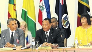 Prime Minister Portia Simpson Miller addressing yesterday’s meeting between Caricom leaders and US President Barack Obama (left) at the UWI. At centre is Caricom Chairman Perry Christie. (PHOTO: BRYAN CUMMINGS)