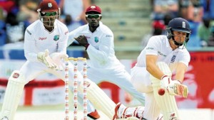 England’s Gary Ballance sweeps a Sulieman Benn delivery on day four of the first Test at Vivian Richards Cricket Stadium, North Sound, Antigua on Thursday, yesterday. (PHOTO: WICB MEDIA/RANDY BROOKS)