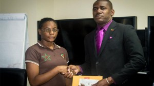 Hon. Shawn Richards presents cheque to Kristal Phillip 