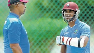 New West Indies head coach Phil Simmons (left) and senior batsman Marlon Samuels chat at practice yesterday before the first Test against England at Vivian Richards Cricket Stadium, North Sound, Antigua. (PHOTO: WICB MEDIA/RANDY BROOKS)