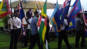 Volunteers from the Department of Youth Affairs showcase the flags of the countries of the region that are a part of the Commonwealth during Tuesday’s opening ceremony of the Caribbean Region Commonwealth Youth Ministers Meeting. (Photo by Kadeem Joseph) 