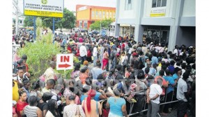 Hundreds of customers gather yesterday at the front of the passport office to process their documents before a May 26 rise in application fees that was later pushed back to June 1.