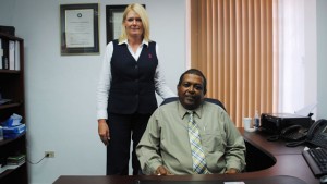 Scotiabank’s General Manager and Country Head Mr Devanand (Dave) Ramsumair (seated), and Ms Charlene Acquisto, Manager for Operations and Administration.