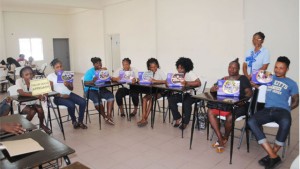 PEP Life Skills Facilitator Ms Gloria Mills instructing a mixed class of PEP Cosmetology and Electrical Trainees at the New Town Community Centre.