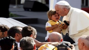 Pope Francis kisses a child as he arrives to lead a mass in Turin, Italy, during a two-day pastoral visit June 21, 2015. REUTERS/Alessandro Garofalo TPX IMAGES OF THE DAY 
