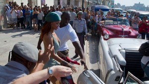 Fans take photographs of pop artist Rihanna as she gets on an American classic car after a photo shoot with photographer Annie Leibovitz in Havana, Cuba on Friday. (Photo: Hoy.com)