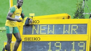 Usain Bolt poses beside the digital clock displaying his world record 19.19 seconds done at the Berlin World Championships in 2009.