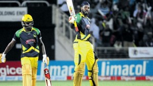 Jamaica Tallawahs Captain Chris Gayle acknowledges the applause after scoring a century against Trinidad and Tobago Red Steel in their Hero CPL match at Sabina Park last night. Jermaine Blackwood looks on. (PHOTO: BRYAN CUMMINGS)