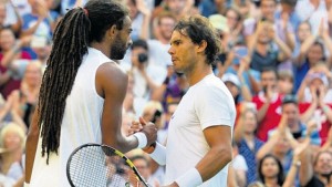 Germany's Dustin Brown (left) shakes hands with Spain's Rafael Nadal after winning their men's singles second-round match of the 2015 Wimbledon Championships at The All England Tennis Club in Wimbledon, London, England, yesterday. Brown won 7-5, 3-6, 6-4, 6-4. (PHOTOS: AFP)