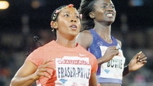 Shelly-Ann Fraser-Pryce (left) of Jamaica, wins the women’s 100m race ahead of Tori Bowie of the US at the IAAF Athletics Diamond League meeting at Stockholm Olympic Stadium yesterday. (PHOTO: AP)