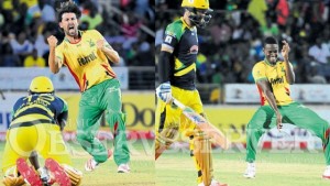 David Wiese of Guyana Amazon Warriors celebrates the wicket of Jamaica Tallawahs’s Andre Russell during their Hero CPL T20 game at Sabina Park yesterday AND Guyana Amazon Warriors Ronsford Beaton reacts after dismissing Tallawahs’ Daniel Vettori at Sabina Park last night. 
