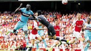 West Ham United’s Senegalese midfielder Cheikhou Kouyate (left) scores the opening goal of the English Premier League football match against Arsenal at the Emirates Stadium in London yesterday.