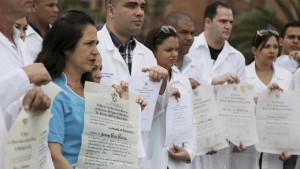 Cuban doctors show their diplomas during a protest to draw attention to their plight to get U.S. visas on Saturday.