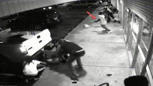 People are pictured outside Solo Insurance Services in St. Louis, Missouri in this still image capture from August 9, 2015 surveillance video footage in this August 11, 2015 St. Louis County Police Department handout photo. Police say the man indicated by the arrow is Tyrone Harris, who was later shot by police. REUTERS/St. Louis County Police Department/Handout