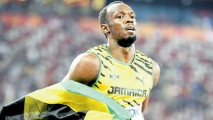 BEIJING, China — Jamaica’s Usain Bolt celebrates with the Jamaican flag after winning the final of the men’s 100 metres at the 2015 IAAF World Championships in Beijing yesterday.