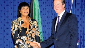 Prime Minister Portia Simpson Miller greets British Prime Minister David Cameron upon his arrival at Jamaica House yesterday.