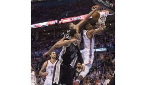 Danny Green #14 and Tim Duncan #21 of the San Antonio Spurs try to stop Russell