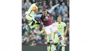 Manchester City’s French defender Bacary Sagna (left) jumps for a header with Aston Villa’s Ghanaian striker Jordan Ayew during their English Premier League match at Villa Park in Birmingham, England, yesterday. The game ended 0-0.