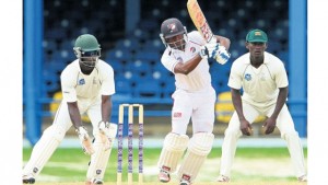 Steven Katwaroo of Trinidad and Tobago Red Force plays down the leg side as Jamaica Scorpions’ wicketkeeper Chadwick Walton and Paul Palmer react during their regional first-class game at Queen’s Park Oval yesterday.