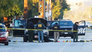 FBI and police investigator are seen around a vehicle in which two suspects were shot following a mass shooting in San Bernardino, California December 3, 2015. Authorities on Thursday were working to determine why Syed Rizwan Farook, 28, and Tashfeen Malik, 27, who had a 6-month-old daughter together, opened fire at a holiday party of his co-workers in Southern California, killing 14 people and wounding 17 in an attack that appeared to have been planned