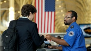 An officer from the Transportation Security Administration checks travel documents for passengers traveling through Reagan National Airport November 25, 2015 in Arlington, Virginia.