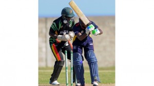 Guyana Jaguars’ wicketkeeper Anthony Bramble (left) looks on as Aaron Jones is bowled during the Group ‘B’ match against Combined Campuses & Colleges Marooners in the NAGICO Super50 Tournament on Monday at the St Paul’s Sports Complex.