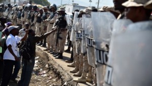 Haitian police stand in front of the Haitian Parliament, in Port-au-Prince, on January 11, 2016, during a protest against the first session of the Parliament.