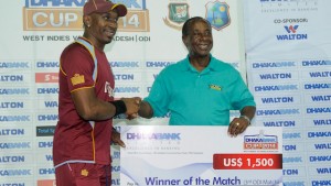 Presentation time: St Kitts Cricket Association’s Stanley Franks (right) presents a cheque to Dwayne Bravo following an ODI between West Indies and Bangladesh in 2014. (WICB media)