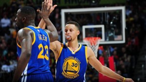 Stephen Curry #30 of the Golden State Warriors shakes hands with Draymond Green #23 of the Golden State Warriors during the game against the Atlanta Hawks on February 22, 2016 at Philips Center in Atlanta, Georgia