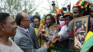 MINISTER OF CULTURE, GENDER, ENTERTAINMENT AND SPORT, OLIVIA GRANGE (LEFT), LOOKS ON AS HIS IMPERIAL HIGHNESS PRINCE ERMIAS SAHLE-SELASSIE, GREETS MEMBERS OF THE RASTAFARI COMMUNITY AT THE NORMAN MANLEY INTERNATIONAL AIRPORT.