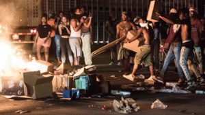 Protestors put cargo from tractor trailers onto a fire on I-85 (Interstate 85) during protests following the death of a man shot by a police officer on Wednesday in Charlotte, North Carolina.