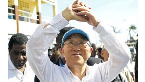 UN Secretary-General Ban Ki-moon makes a gesture of solidarity to people whose homes were destroyed by Hurricane Matthew, as he visits a school where they have sought shelter in Les Cayes, Haiti, on Saturday.