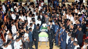 Members of the St George’s College and Jamaica College Manning Cup teams form a guard of honour as pall-bearers remove the casket of Dominic James from the Holy Trinity Cathedral Church yesterday.