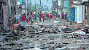 Red Cross workers and residents walk among the damage caused by Hurricane Matthew in Baracoa, Cuba, yesterday. The hurricane rolled across the sparsely populated tip of Cuba overnight, destroying dozens of homes in Cuba’s easternmost city, Baracoa, and leaving hundreds of others damaged.