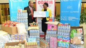 Director general of the Office of Disaster Preparedness and Emergency Management Major Clive Davis (left) receives a donation of cash and supplies from chief executive officer of National Commercial Bank Foundation Nadeen Matthews at the bank’s Atrium offices in Kingston on Thursday