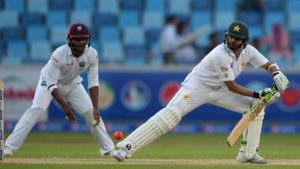 Pakistani batsman Azhar Ali (R) plays a shot on the opening day of the first day-night Test between Pakistan and the West Indies at the Dubai International Cricket Stadium in the Gulf Emirate on October 13, 2016.