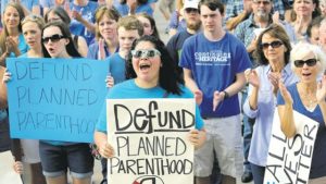 In this July 28, 2015 file photo, Erica Canaut (centre) cheers as she and other anti-abortion activists hold a rally on the steps of the Texas State Capitol in Austin, Texas to condemn the use of tissue samples obtained from aborted foetuses for medical research. Planned Parenthood’s federal funding accounts for about one-third of its annual $1.3 billion budget. Republicans in Congress finally managed to get a bill to President Barack Obama that would have achieved that goal, but he vetoed it in January 2016.